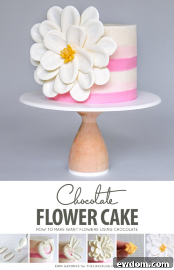 A beautifully decorated White Chocolate Flower Cake featuring a large side statement bloom made from white chocolate petals, resting against a striped buttercream cake.