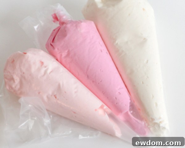 Dividing and tinting buttercream into three colors for striped cake design