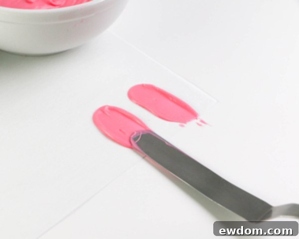 Pink Paradise Flamingo Cake 12 Collection of bright and light pink chocolate brushstroke feathers drying on parchment