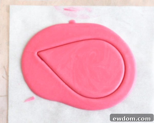 Pink Paradise Flamingo Cake 14 Removing tear drop cutters to reveal molded pink chocolate shapes for the flamingo's body and head