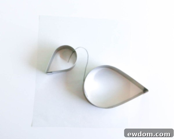 Pink Paradise Flamingo Cake 15 Drawing the flamingo's neck outline on parchment paper using the tear drop shapes as a guide