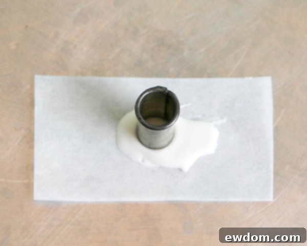 Pink Paradise Flamingo Cake 17 Pouring white chocolate and placing a small circle cutter for the flamingo's eye base