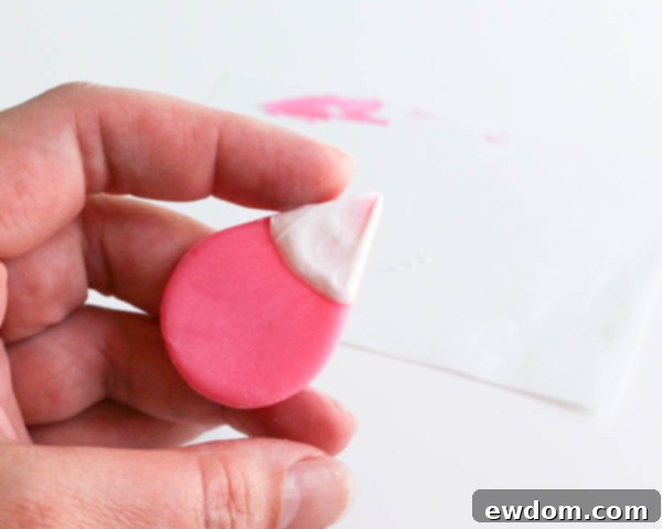 Pink Paradise Flamingo Cake 20 The small pink tear drop with its white chocolate beak base, setting on parchment paper