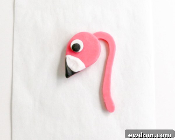 Pink Paradise Flamingo Cake 25 The complete flamingo head with eye, beak, and neck assembly setting on parchment paper