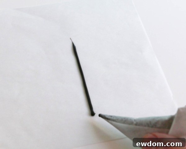 Pink Paradise Flamingo Cake 26 Drawing the flamingo's legs, including a straight and a bent leg, on parchment paper