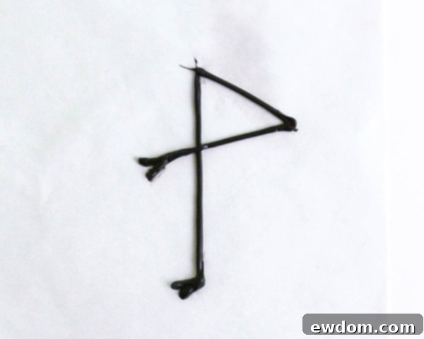 Pink Paradise Flamingo Cake 28 Piping the bent flamingo leg over the straight leg, completing the leg set