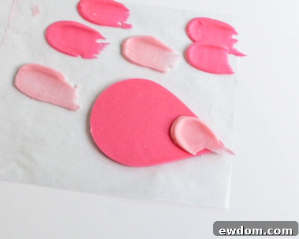 Pink Paradise Flamingo Cake 30 Attaching the first brushstroke feather to the pointed end of the large tear drop