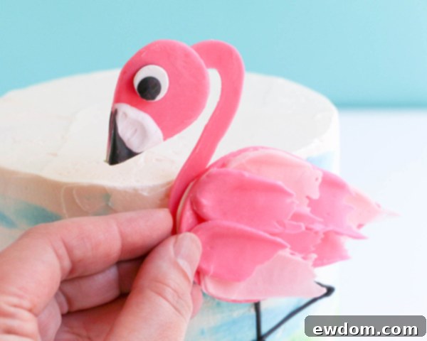 Pink Paradise Flamingo Cake 39 Sliding the flamingo's neck into position behind the rounded edge of the body