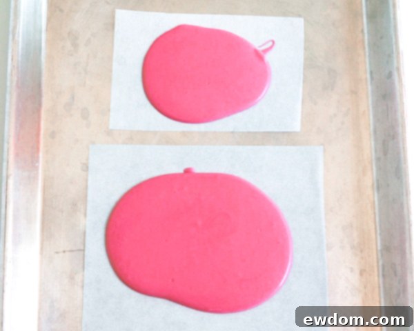 Pink Paradise Flamingo Cake 6 Pouring bright pink chocolate onto parchment paper for the flamingo body