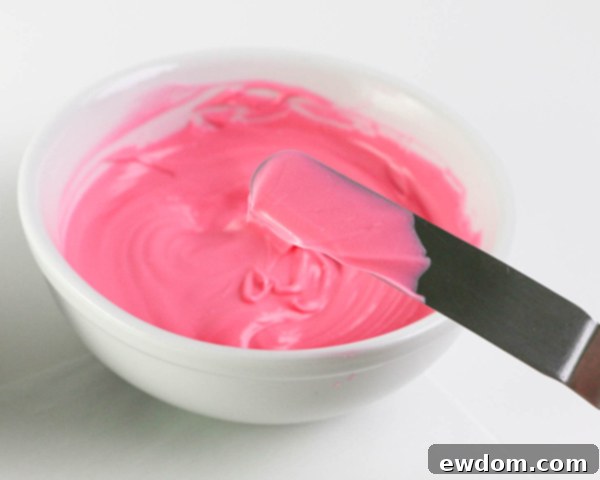 Pink Paradise Flamingo Cake 10 Continuing to create bright pink chocolate brushstroke feathers on parchment paper