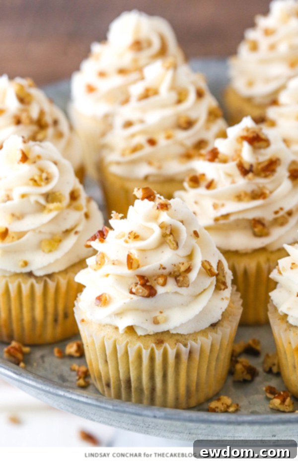Butter Pecan Cupcakes - moist vanilla cupcakes studded with toasted butter pecans and topped with cinnamon buttercream frosting | Deliciously moist and flavorful