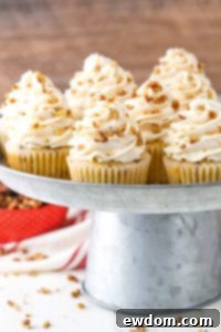 Butter Pecan Cupcakes - moist vanilla cupcakes studded with toasted butter pecans and topped with cinnamon buttercream frosting | by Lindsay Conchar for TheCakeBlog.com