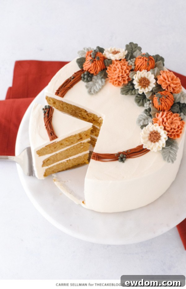 Cozy Pumpkin Spice Treat 7 Beautifully piped buttercream flowers and pumpkins adorning the top of a Pumpkin Spice Cake