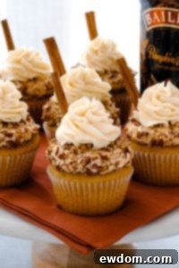 Beautiful Baileys Pumpkin Spice Cupcakes on a rustic wooden board | by Carrie Sellman for TheCakeBlog.com