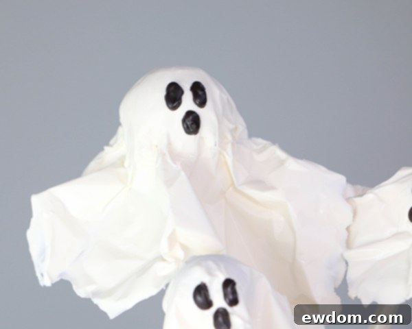 Chocolate Lollipop Ghosts - how to make edible lollipop ghosts for Halloween cakes and cupcakes using white chocolate and suckers | by Erin Gardner for TheCakeBlog.com