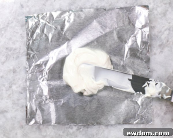 Chocolate Lollipop Ghosts - how to make edible lollipop ghosts for Halloween cakes and cupcakes using white chocolate and suckers | by Erin Gardner for TheCakeBlog.com