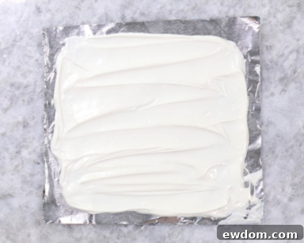 Chocolate Lollipop Ghosts - how to make edible lollipop ghosts for Halloween cakes and cupcakes using white chocolate and suckers | by Erin Gardner for TheCakeBlog.com