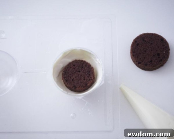 Layering cake and buttercream into chocolate-lined ball molds