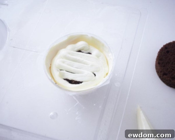 Pressing cake layers into ball mold for Christmas Ornament Cakes