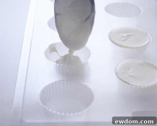 Frozen candy coating caps popped from mold for Christmas Ornament Cakes