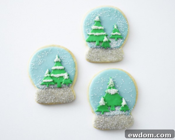 Finished Snow Globe Cookies - Beautifully decorated sugar cookies with snow caps, ready for the holidays by Cakegirls for TheCakeBlog.com