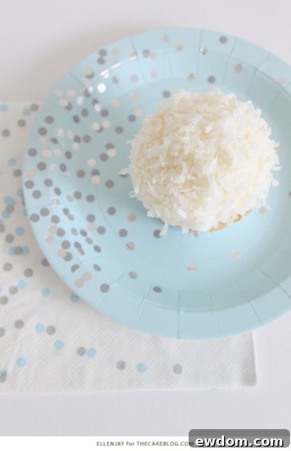 Coconut Cupcakes - fluffy coconut cupcakes made with coconut milk and topped with smooth coconut buttercream and coconut flakes | by ellenJAY for TheCakeBlog.com