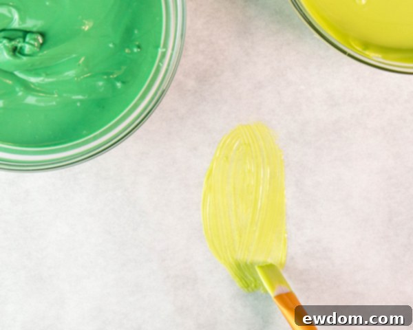 Paint a thin light green leaf outline on parchment paper, ensuring it dries completely before adding the next layer.