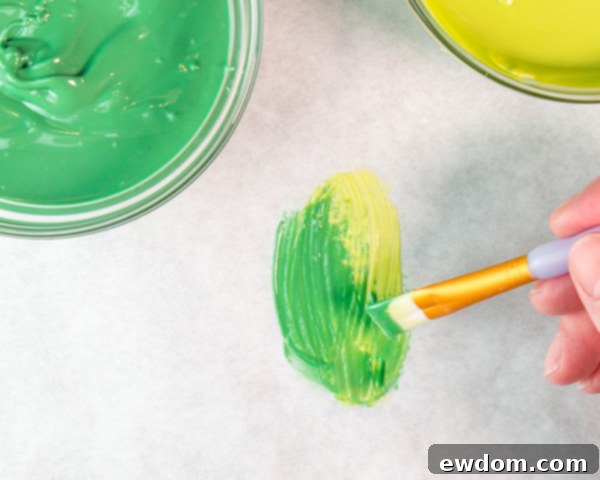 Layer a thicker dark green leaf shape on top of the dried light green outline to create depth and realistic chocolate leaves.