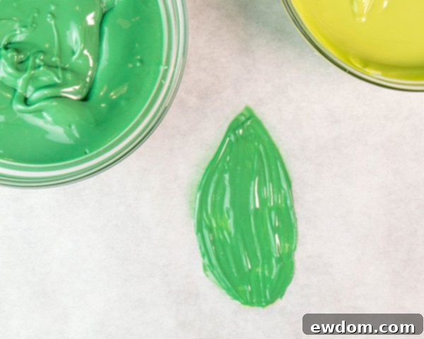 Finish all chocolate leaves, prop them over a cookie sheet edge for natural curvature, and chill until fully hardened.