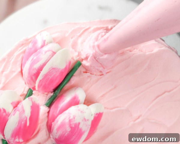 Pipe a buttercream dollop, place two chocolate petals, then secure a third petal over their base with another buttercream dot.