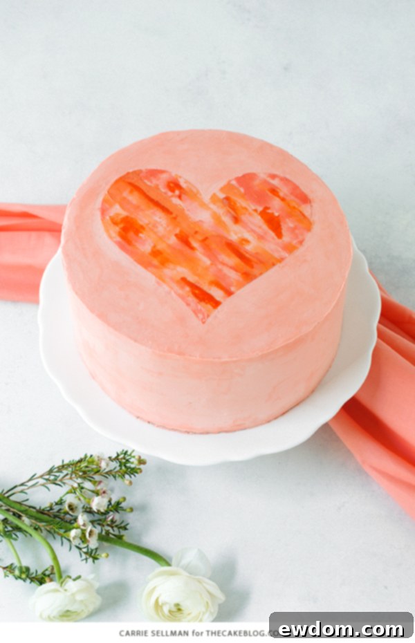 Watercolor Heart Cake - how to paint a watercolor heart cake using buttercream frosting and a parchment paper stencil | by Carrie Sellman for TheCakeBlog.com