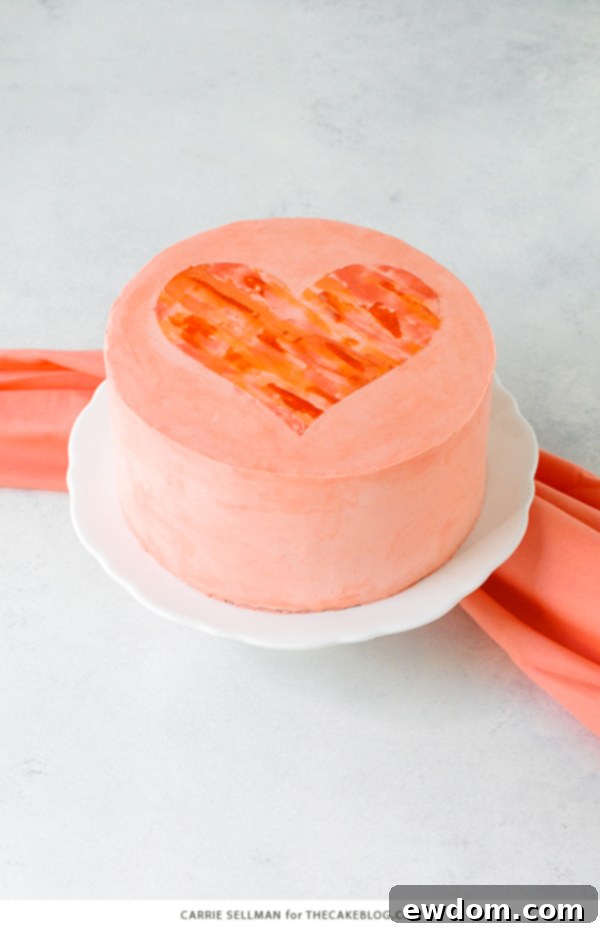 Watercolor Heart Cake - how to paint a watercolor heart cake using buttercream frosting and a parchment paper stencil | by Carrie Sellman for TheCakeBlog.com