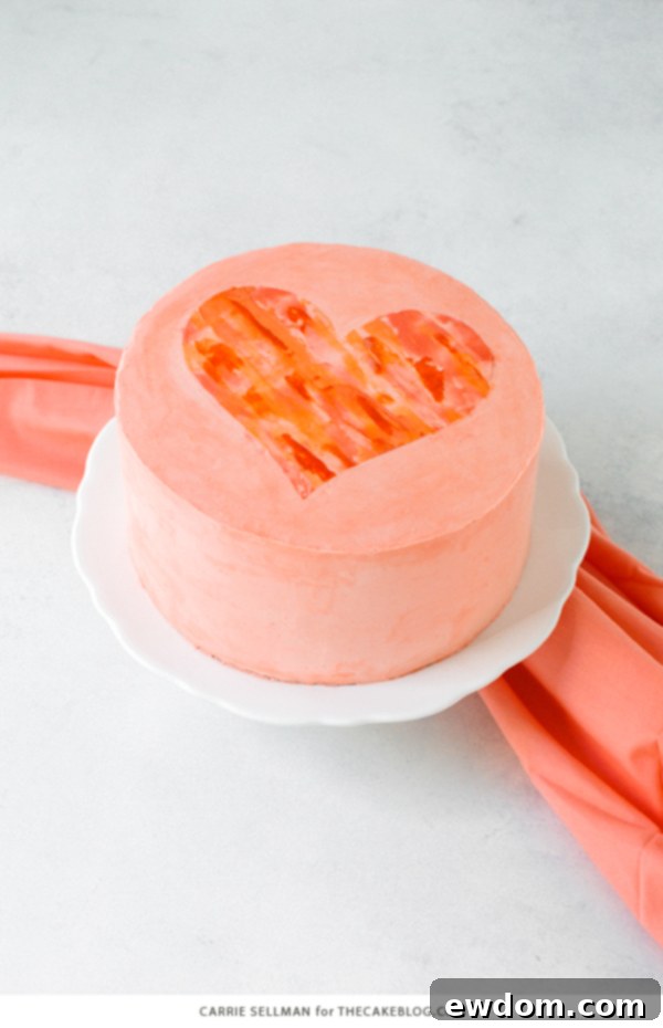 Watercolor Heart Cake - how to paint a watercolor heart cake using buttercream frosting and a parchment paper stencil | by Carrie Sellman for TheCakeBlog.com