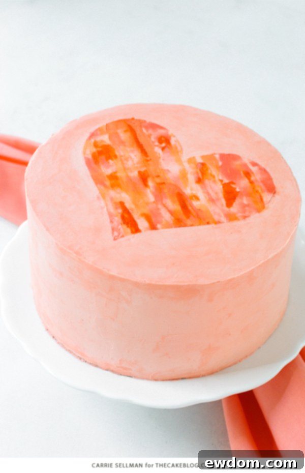 Watercolor Heart Cake - how to paint a watercolor heart cake using buttercream frosting and a parchment paper stencil | by Carrie Sellman for TheCakeBlog.com