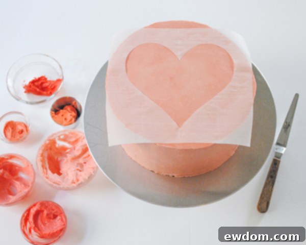 Watercolor Heart Cake - how to paint a watercolor heart cake using buttercream frosting and a parchment paper stencil | by Carrie Sellman for TheCakeBlog.com