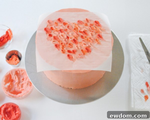 Watercolor Heart Cake - how to paint a watercolor heart cake using buttercream frosting and a parchment paper stencil | by Carrie Sellman for TheCakeBlog.com