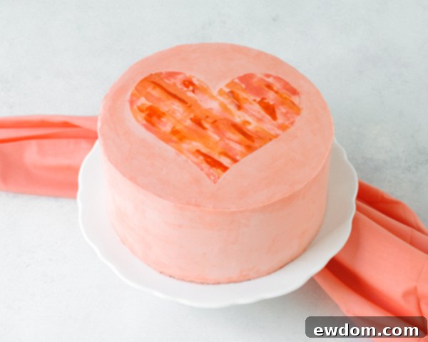 Watercolor Heart Cake - how to paint a watercolor heart cake using buttercream frosting and a parchment paper stencil | by Carrie Sellman for TheCakeBlog.com