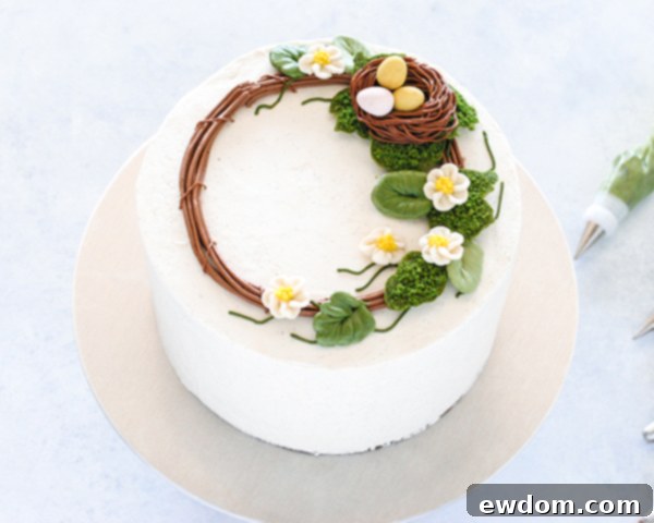 Spring Blossom Wreath Cake 17 Buttercream cherry blossoms carefully placed onto the Spring Wreath Cake, enhancing the beauty of the wreath design.