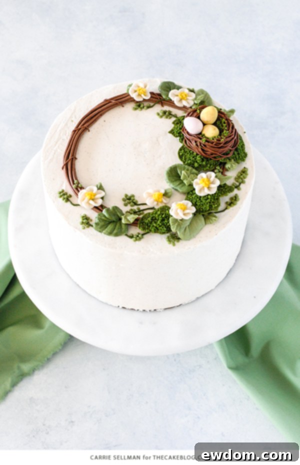 Spring Blossom Wreath Cake 3 Close-up of the Spring Wreath Cake showcasing beautifully piped buttercream leaves and vibrant green berries, creating a lush, fresh look.