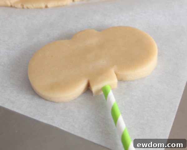 Close-up of bunny cookie pops evenly spaced on a baking sheet before chilling