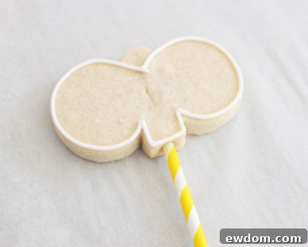 Piping a pink nose and then flooding the main bunny face with white icing