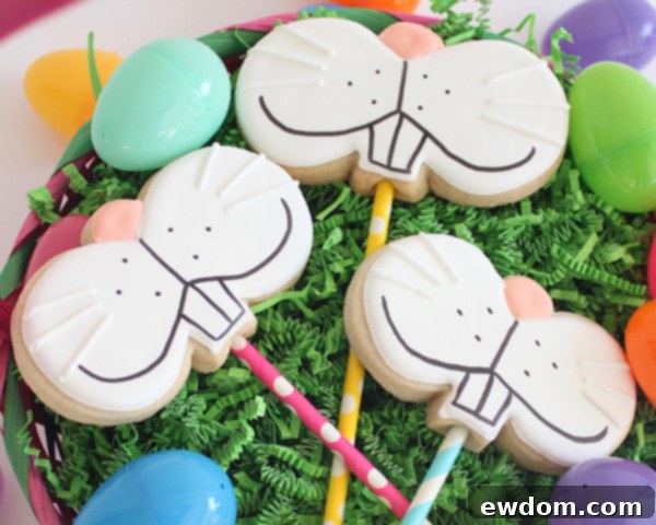 Adding white icing whiskers to a fully decorated bunny face cookie pop