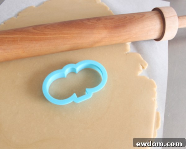 Rolled sugar cookie dough on a surface, ready for cutting with a bunny cookie cutter