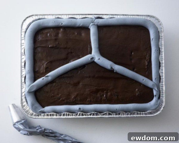 Mid-Century Meal Cake 12 Assembling the TV Dinner Cake: Piping gray buttercream for tray divisions, adding candy vegetables, and mashed potato buttercream. By Cakegirls for TheCakeBlog.com