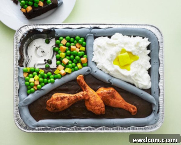 Mid-Century Meal Cake 4 Creative TV Dinner Sheet Cake featuring a chocolate cake base, candy fried chicken, buttercream mashed potatoes, and Starburst/Sixlet vegetables. A perfect DIY cake for Father's Day and April Fools Day. By Cakegirls for TheCakeBlog.com