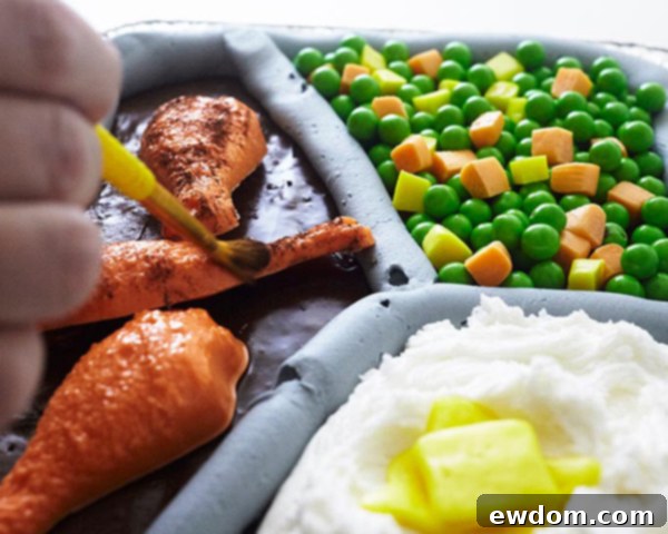 Mid-Century Meal Cake 5 Delicious TV Dinner Sheet Cake decorated with candy chicken, butter, and buttercream mashed potatoes and vegetables. A fun and unique dessert idea. By Cakegirls for TheCakeBlog.com