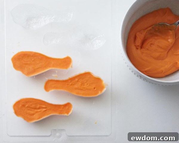 Mid-Century Meal Cake 7 Step-by-step: Melting orange candy coating for the TV Dinner Cake's fried chicken pieces. Easy DIY dessert for Father's Day. By Cakegirls for TheCakeBlog.com