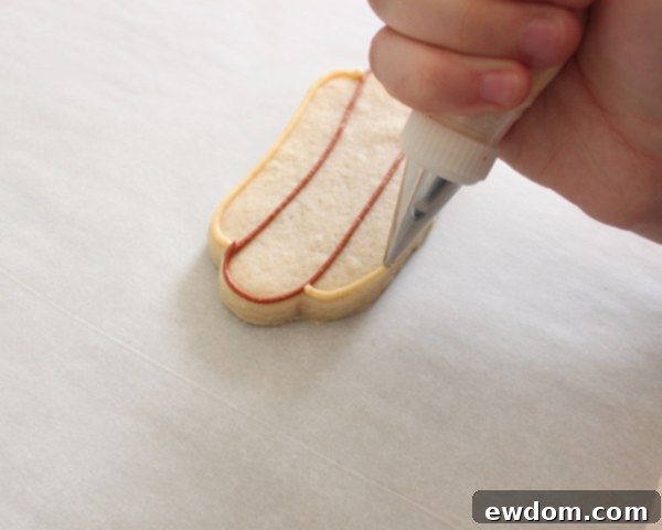 Flooding hot dog bun with ivory royal icing
