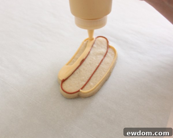 Flooding hot dog with red-brown royal icing