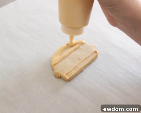 Adding white nonpareil sesame seeds to hamburger bun cookies
